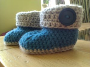 Hand crocheted, blue and grey booties.