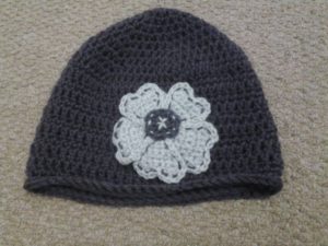 Heather purple and grey crocheted flower detail beanie hat.