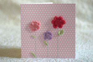 Hand made and hand stitched, pink and lilac crocheted flowers and green felt leaves greetings card. Left blank inside for your own message. Size w15.2 x h15.2cm