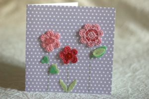 Hand made and hand stitched, crocheted pink flower and felt green leaf greetings card. Left blank inside for your own message. Size w15.2 x h15.2cm. £4.50 (exc P+P)