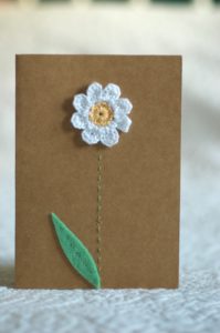 Hand made and hand stitched, white crocheted daisy flower and green felt leaf greetings card. Left blank inside for your own message. Size w10.5 x h14.8cm