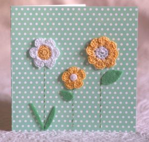 Hand made and hand stitched, yellow and white crocheted flowers and felt green leaves greetings card. Left blank inside for your own message. Size w15.2 x h15.2cm