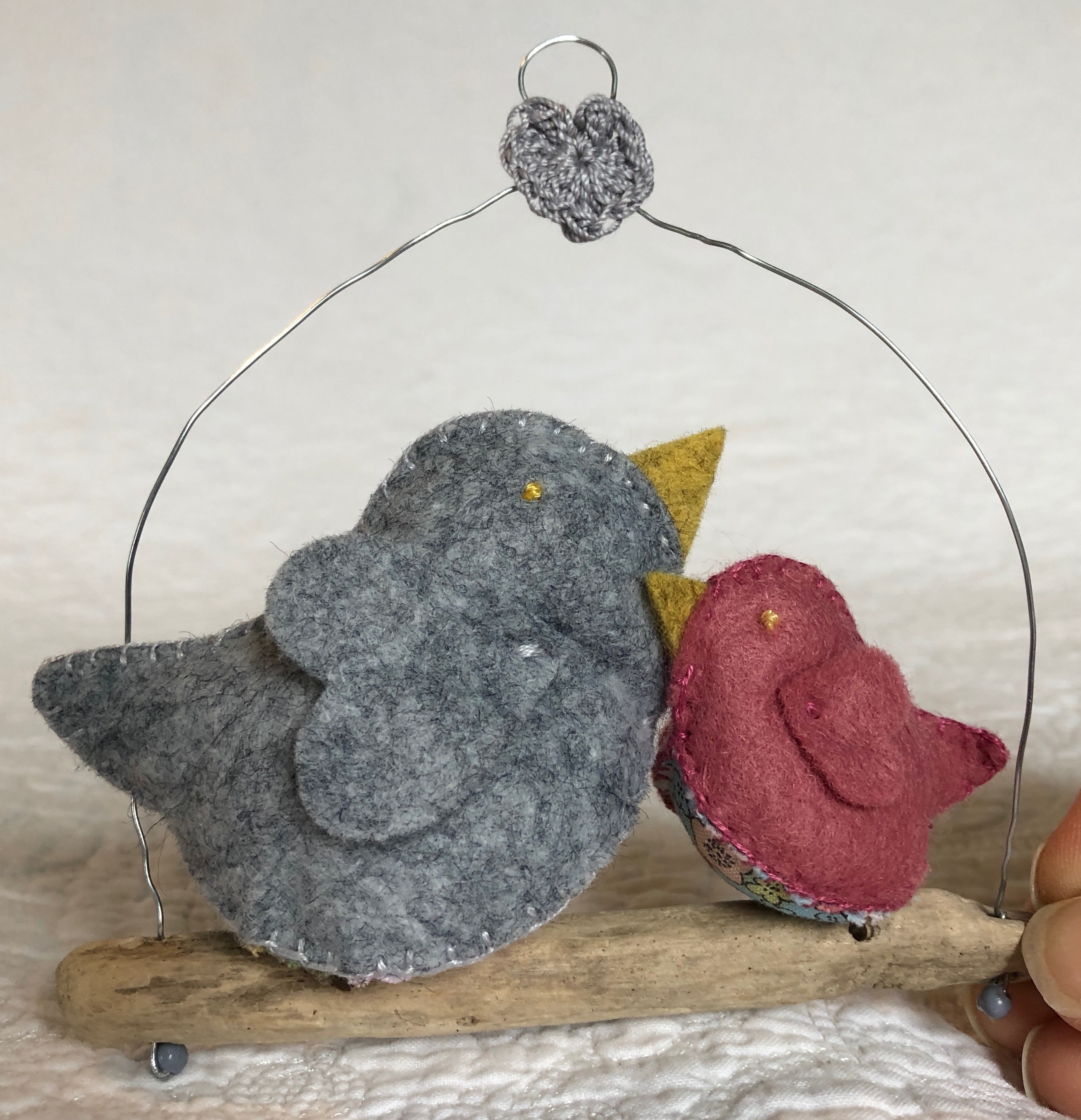Hanging decoration. Hand sewn in grey and dusky pink felt and floral cotton fabric little birds on a driftwood branch.