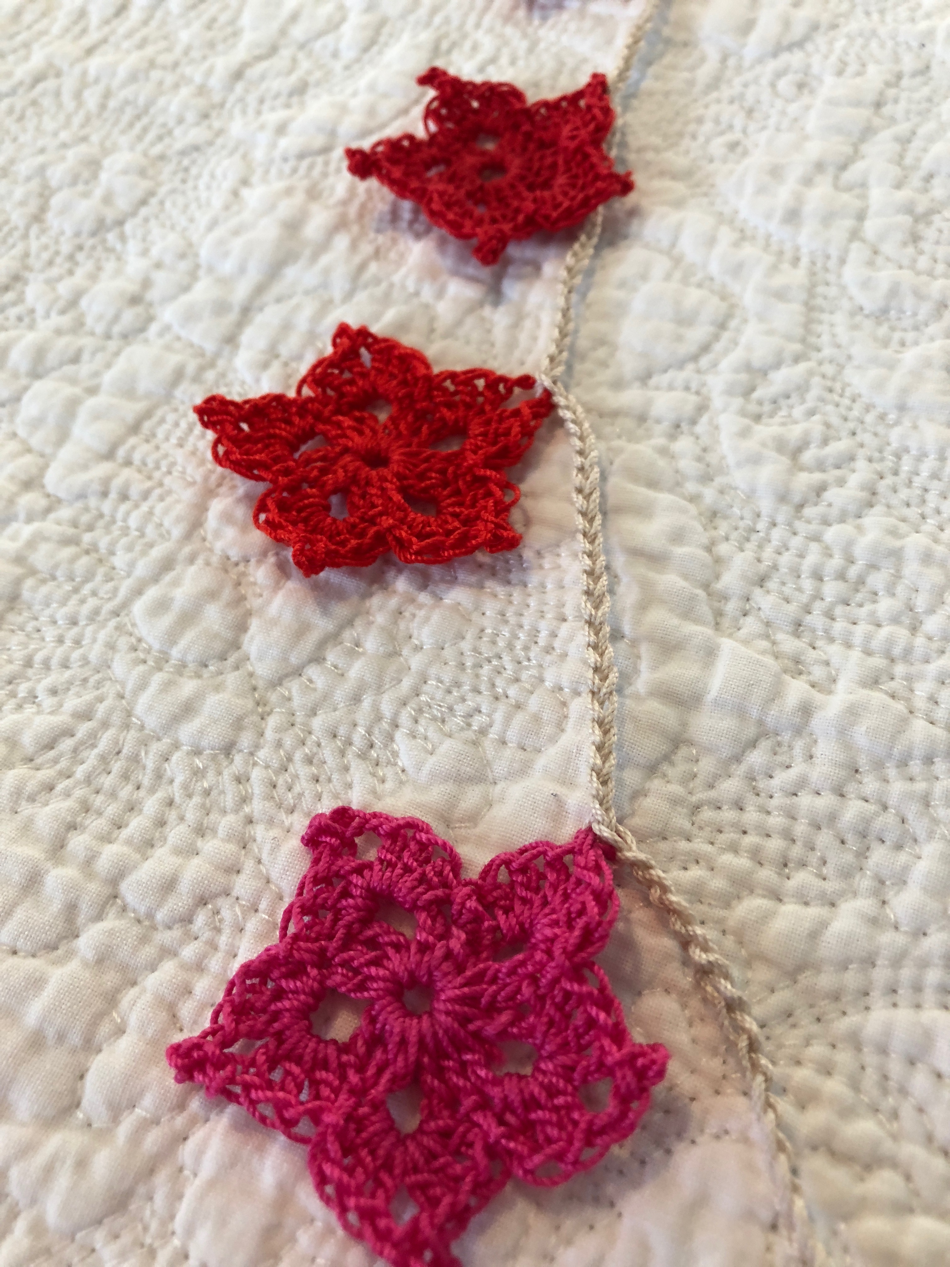 Hand made, crocheted, vintage style, cotton star garland in a gradient of red to purple shades.