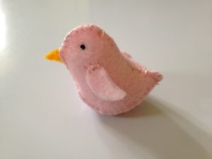 Tiny pink felt bird.