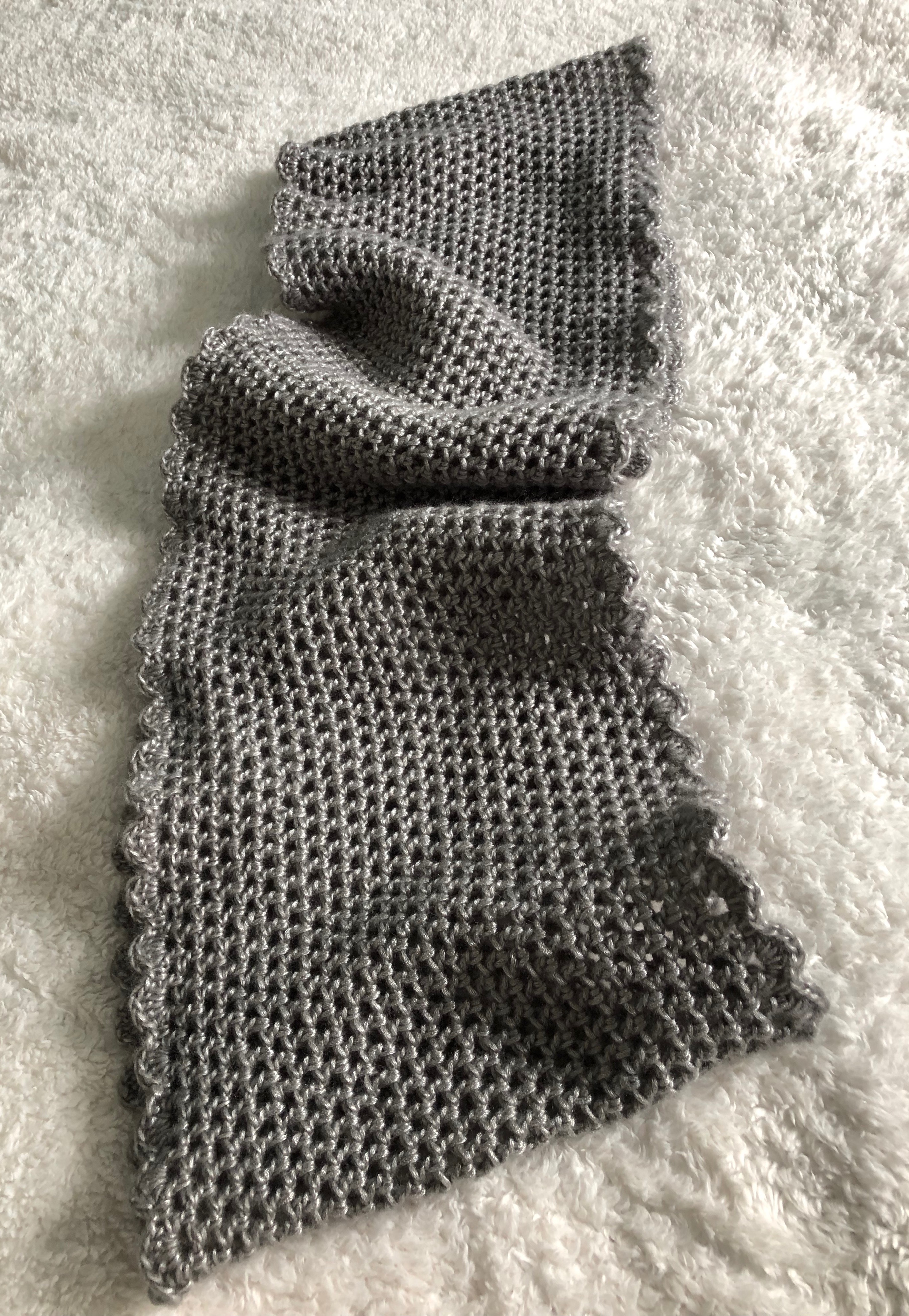 A soft pearl grey hand crocheted infinity scarf.