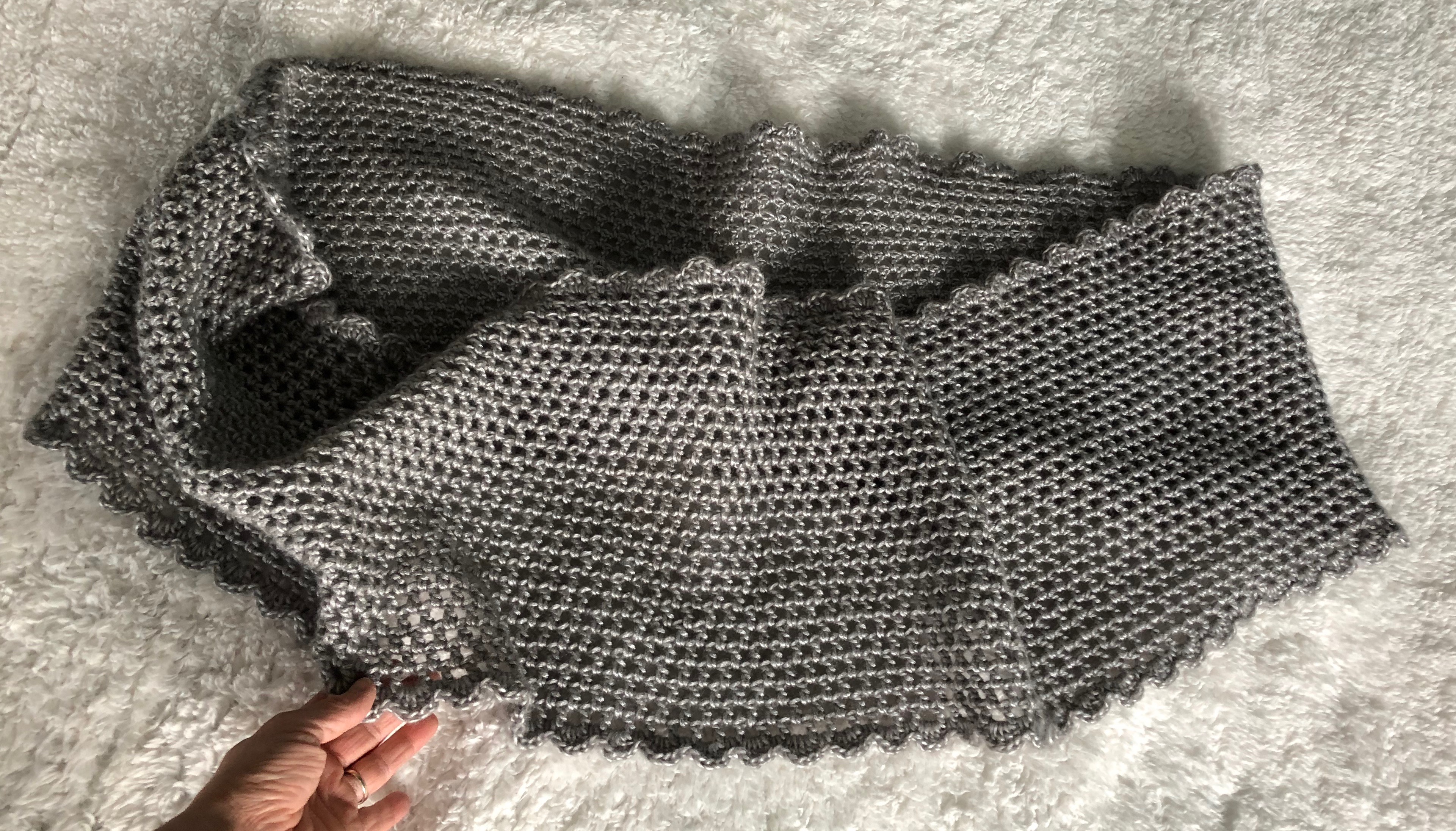 A soft pearl grey hand crocheted infinity scarf.