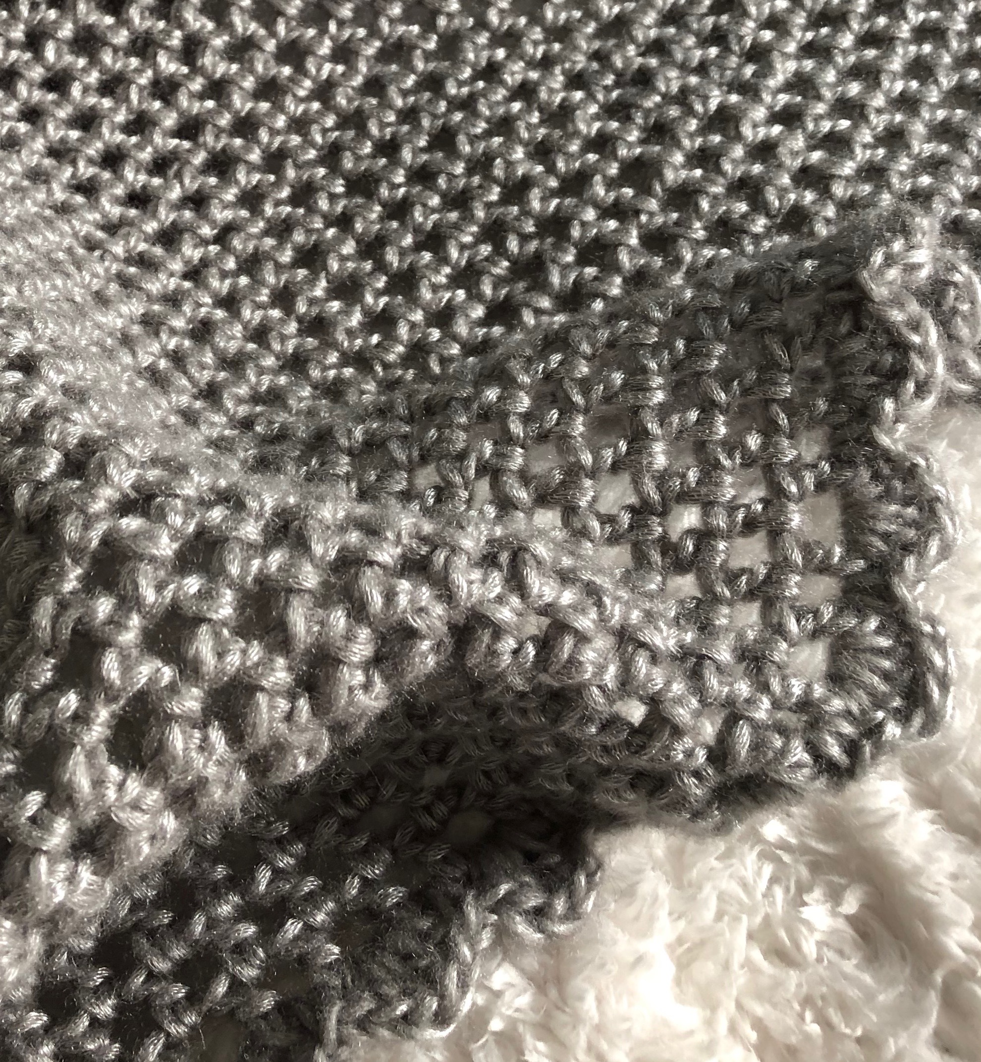 A soft pearl grey hand crocheted infinity scarf.