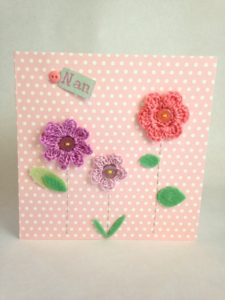 Hand crocheted and hand stitched pink flowers greetings card.