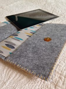 Grey and multi coloured leaf pattern fabric and felt tablet case.