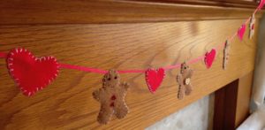 Mini felt gingerbread men and red hearts garland.