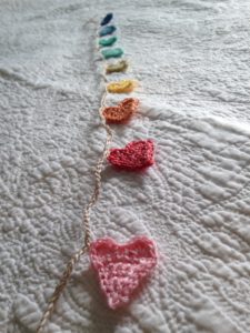Tiny crocheted pastel coloured heart bunting.