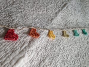 Tiny pastel multi coloured heart crocheted bunting.
