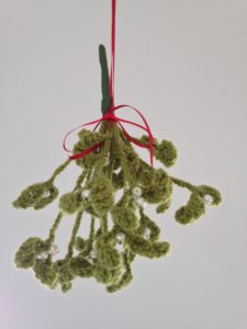 Green hanging crochet mistletoe decoration with pearl beads.