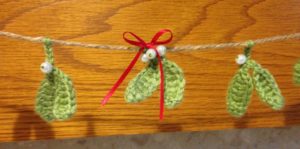 Green crocheted mistletoe garland with pearl beads.