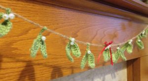Green crocheted mistletoe garland with pearl beads.