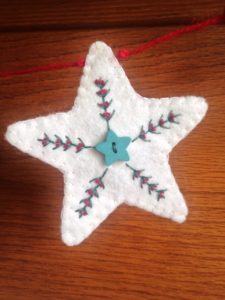 White felt, hand embroidered star.