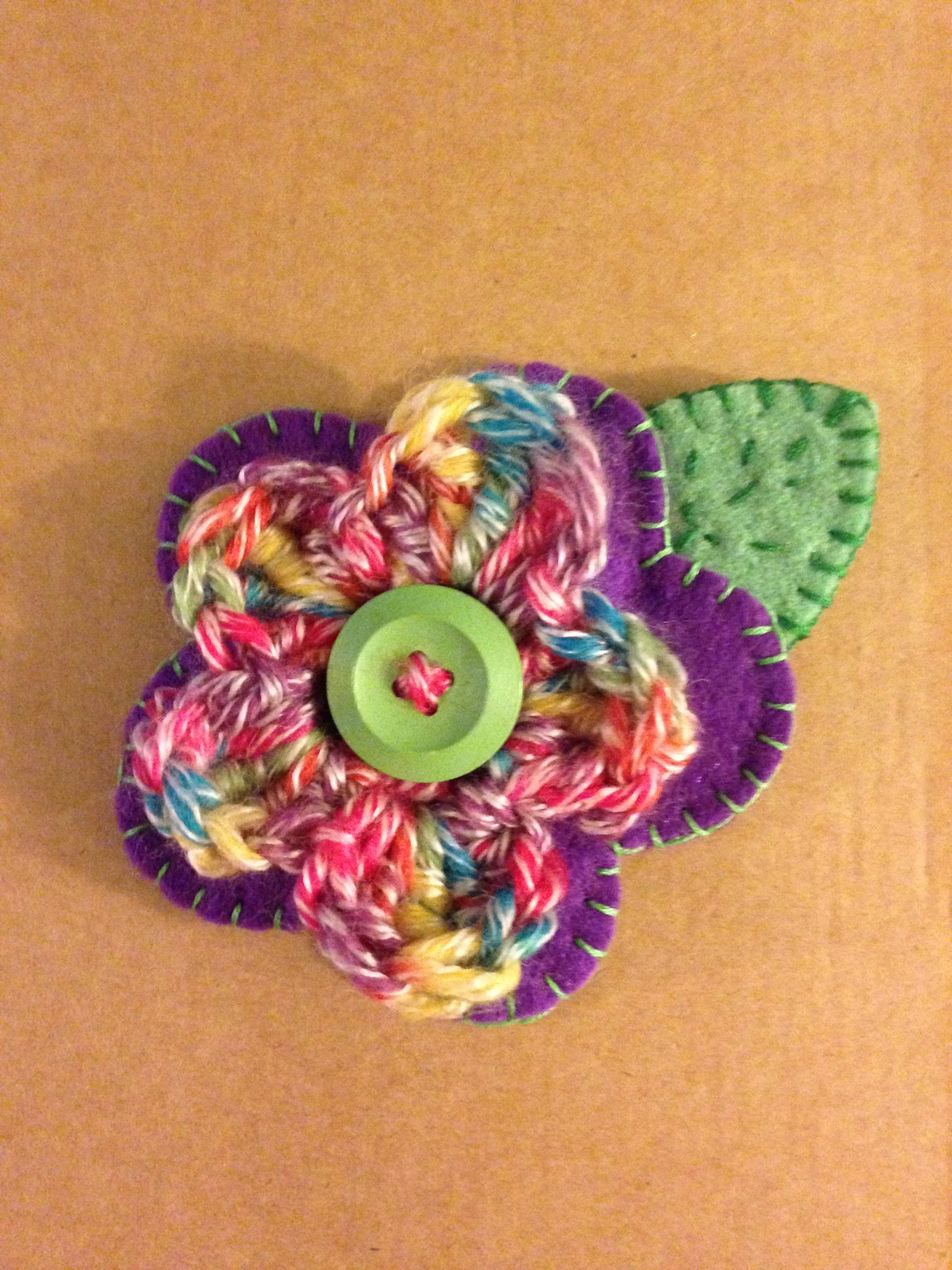 Hand sewn felt and crocheted flower brooch.