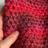 A handmade, crocheted neck warmer, in a variegated colour combination of red and purple tones. Made using a mix of two lightweight yet warm yarns. Acrylic/Wool/Mohair mix.
