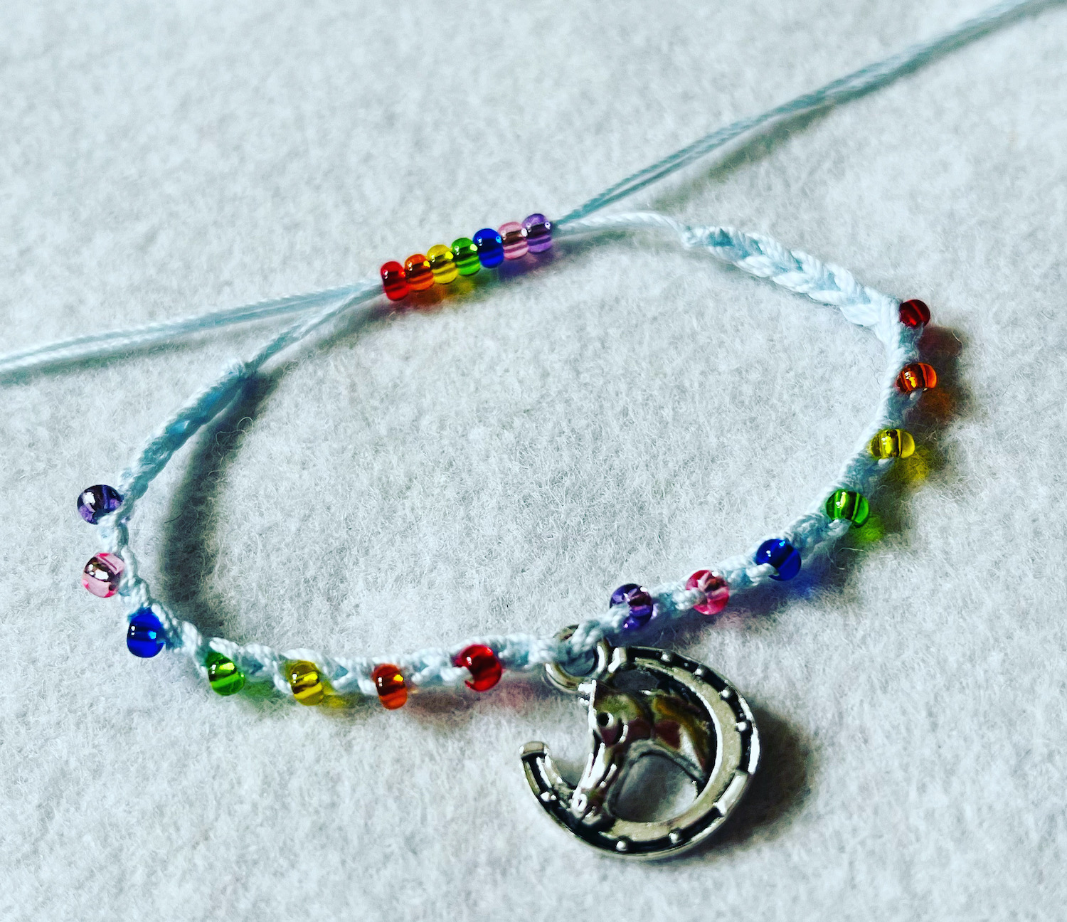 Horse charm and rainbow beaded bracelet.