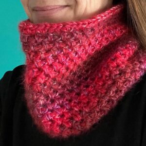 A handmade, crocheted neck warmer, in a variegated colour combination of red and purple tones. Made using a mix of two lightweight yet warm yarns. Acrylic/Wool/Mohair mix.