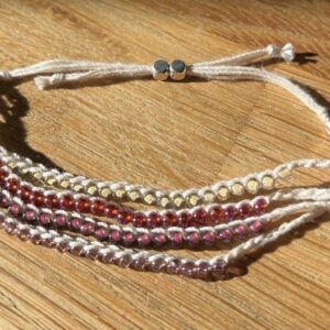 4 strand, fully adjustable bracelet with glass and silver metal beads. Handmade using 100% cotton. Eco-friendly and fully recyclable.