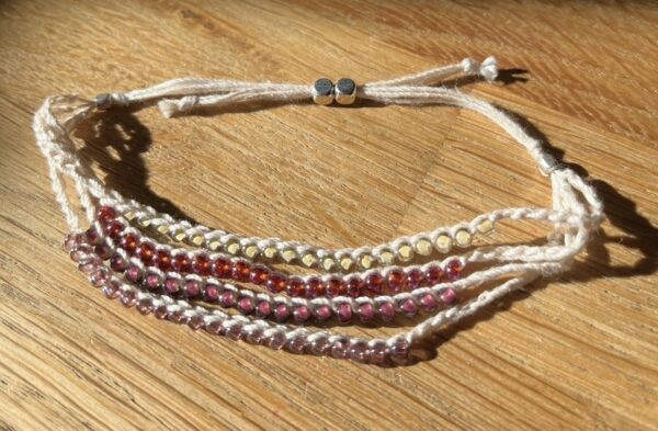 4 strand, fully adjustable bracelet with glass and silver metal beads. Handmade using 100% cotton. Eco-friendly and fully recyclable.