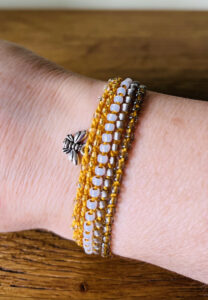 5 strand, fully adjustable bracelet with glass and metal beads and silver metal coloured bee charm. 
