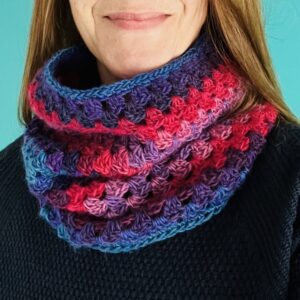 A handmade, block textured, crocheted neck warmer. Made using a soft and lightweight 70% acrylic/ 30% Wool mix yarn in a range of warm and vibrant jewel colours.