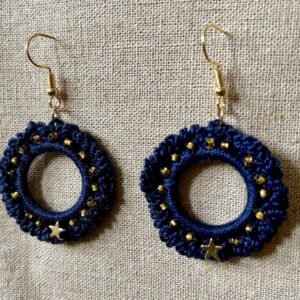 Hand made, crocheted, mini wreath earrings. Made using 100% cotton in a rich navy blue colour with a gold metal star and gold glass beading details. The earring hooks are made from a gold plated brass and are nickel, lead and cadmium free. Each earring measures approximately 3.5cm wide by 5.5cm Height (including hook).