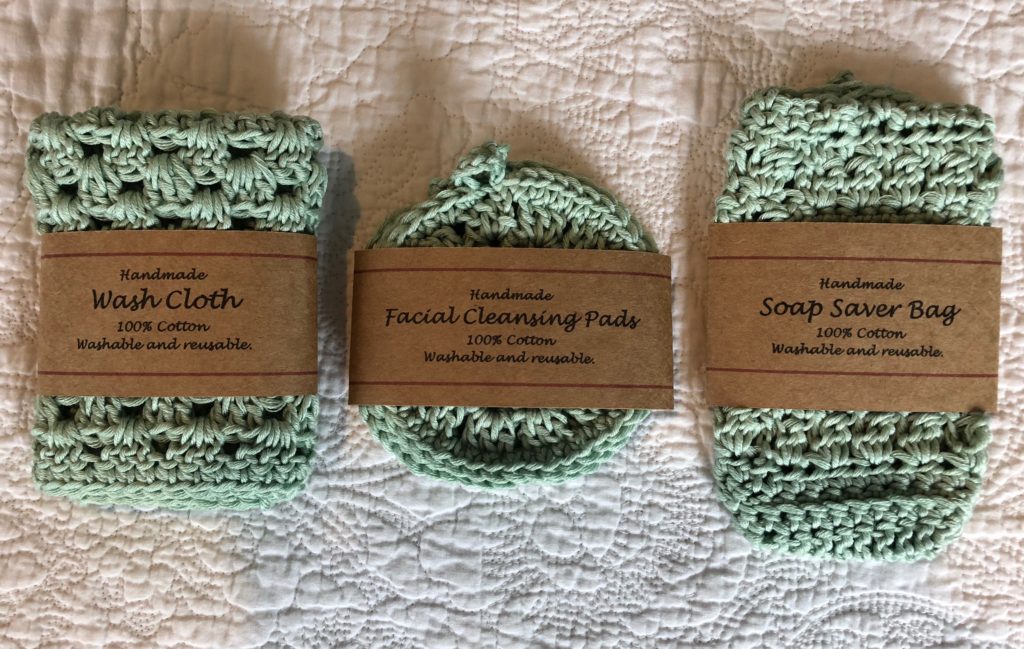 A set of 3 large facial scrubbies with hanging loop, washcloth and soap saver bag. Hand crocheted using 100% cotton. Reusable, washable and eco-friendly.
