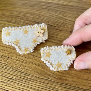 Handmade fabric and felt brooch with crocheted edging, a metal star bead detail and a metal locking fastening. Regular pants = Approximate size 6cm Width x 4cm Height. Mini pants = Approximate size 4cm Width x 2.5cm Height.