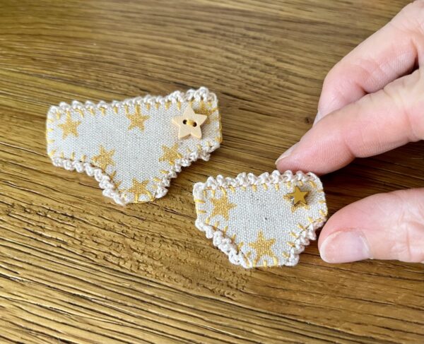 Handmade fabric and felt brooch with crocheted edging, a metal star bead detail and a metal locking fastening. Regular pants = Approximate size 6cm Width x 4cm Height. Mini pants = Approximate size 4cm Width x 2.5cm Height.