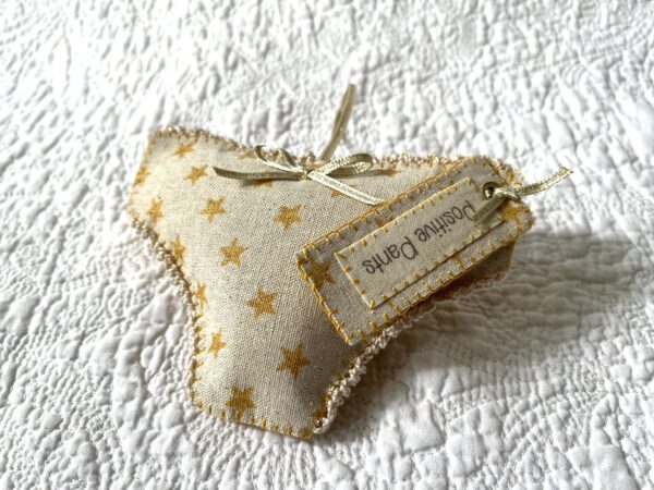 Gold star fabric, positive pants hanging decoration. A handmade, fabric and felt hanging decoration, with crocheted edging and ribbon bow, a positive pants label and hanging ribbon.