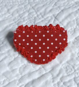 Mini handmade fabric and felt brooch with crocheted edging and a metal locking fastening. 

Approximate size 4cm Width x 2.5cm Height.