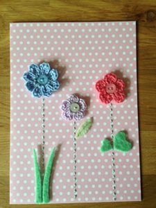 Hand made and hand stitched, blue, lilac and grey crocheted flowers and green felt leaves greetings card. Left blank inside for your own message. Size w12.7 x h17.7cm