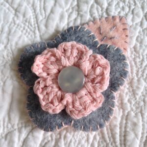 Grey and pale pink hand sewn felt and crocheted flower brooch.