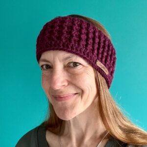 A hand crocheted, textured, ear warmer, in a rich Plum colour. Made using a super soft, warm and chunky Acrylic 75%/ Wool 25% mix yarn.