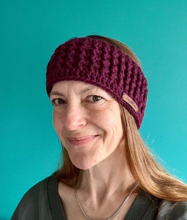 A hand crocheted, textured, ear warmer, in a rich Plum colour. Made using a super soft, warm and chunky Acrylic 75%/ Wool 25% mix yarn.