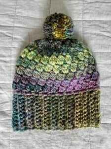 A soft and chunky textured hat with a large detachable bobble. Made in a subtle mix of heather tones. Made using a very soft and chunky, yet lightweight, 20% Wool/80% acrylic mix yarn. One size Adult. 