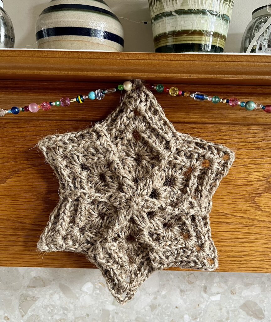 A hand crocheted, hanging star decoration. Made using 100% natural Jute. Approximate size 24cm Wide x 24cm Height.