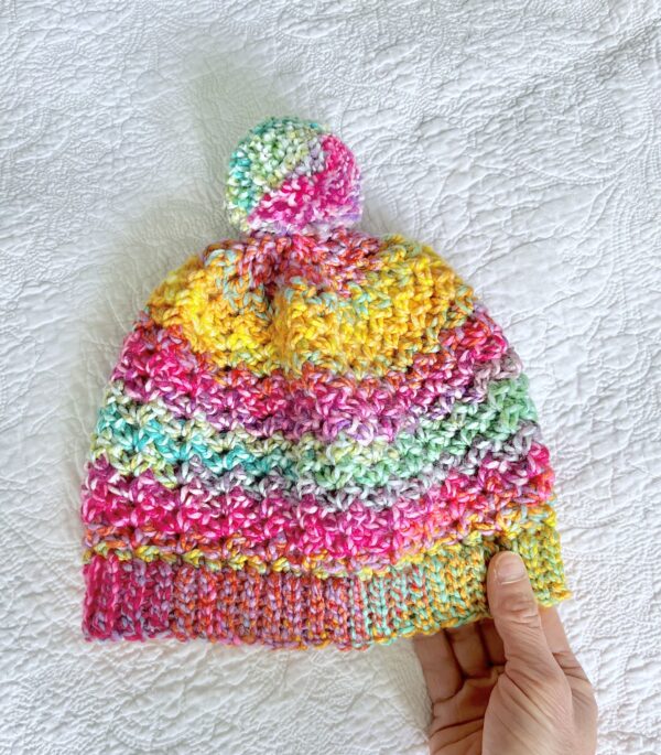 A soft and chunky textured hat with a large detachable bobble. Made in a vibrant mix of rainbow colours, using a very soft and chunky, yet lightweight Acrylic yarn. yarn .