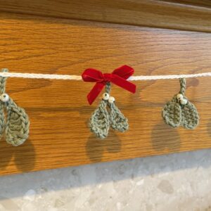 Mistletoe garland with velvet bow.