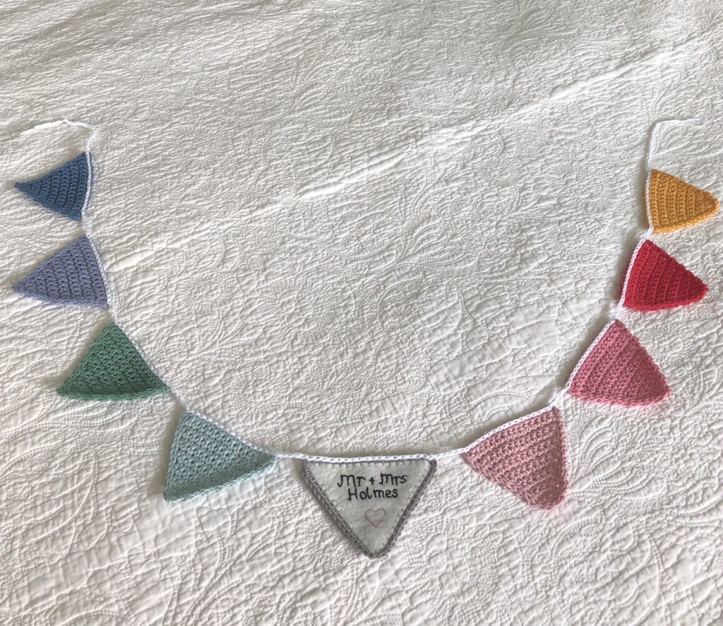 Hand crocheted bunting with personalised and  hand embroidered felt centre flag.