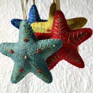 A handmade felt star hanging decoration. Medium size. Handmade in felt and hand sewn and embellished with glass beads and a gold hanging ribbon. Approximate size 9cm x 9cm (not including hanging ribbon) This is a decoration only, and is NOT a toy. Keep out of the reach of babies and small children due to the small parts.