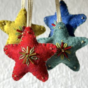 A handmade felt star hanging decoration. Small size. Handmade in felt and hand sewn and embellished with glass beads and a gold hanging ribbon. Approximate size 6cm x 6cm (not including hanging ribbon) This is a decoration only, and is NOT a toy. Keep out of the reach of babies and small children due to the small parts.