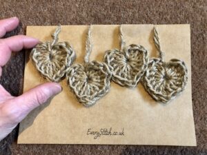 A set of 4 individual hanging heart decorations. Hand crocheted and made in 100% natural jute.