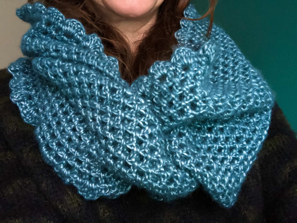 A soft pearl teal coloured hand crocheted infinity scarf. 