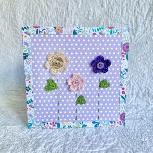 A trio of crocheted flowers and leaves, with buttons and hand stitched details. This spotty card has a blank white insert for your own message, and an envelope is included. Approximate size 15cm x 15 cm. Made using 100% cotton. Eco-friendly, Vegan friendly and fully recyclable.