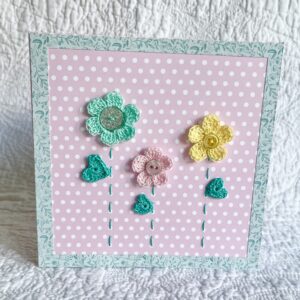 A trio of crocheted flowers and leaves, with buttons and hand stitched details. This spotty card has a blank white insert for your own message, and an envelope is included. Approximate size 15cm x 15 cm. Made using 100% cotton. Eco-friendly, Vegan friendly and fully recyclable.